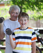 © Denizo - Grandfather and grandson of exercising with dumbbells