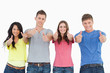 © WavebreakmediaMicro - Four people standing beside each other give thumbs up