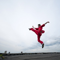 Wall Mural - Wushoo man in red practice martial art