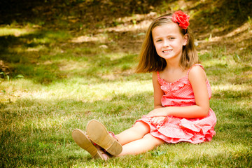 Summer child portrait of smiling pretty young girl outdoors