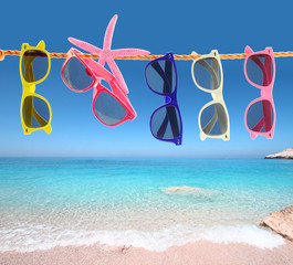 Collection of sunglasses on the beach