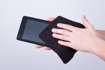 hands cleaning tablet screen