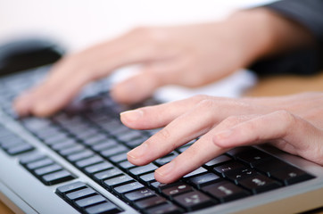 Hands typing on the keyboard