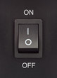 Black toggle switch on black surface - On Off