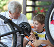 © Denizo - Grandfather and grandson of a bicycle repair