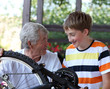 © Denizo - Grandfather and grandson of a bicycle repair