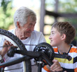 © Denizo - Grandfather and grandson of a bicycle repair