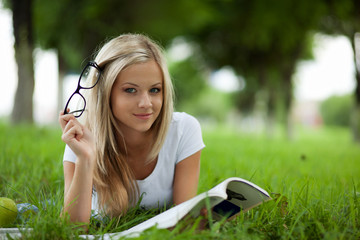 Beautifull college student in park. Outdoor shot