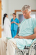© WavebreakmediaMicro - Male patient in a wheelchair next to nurses