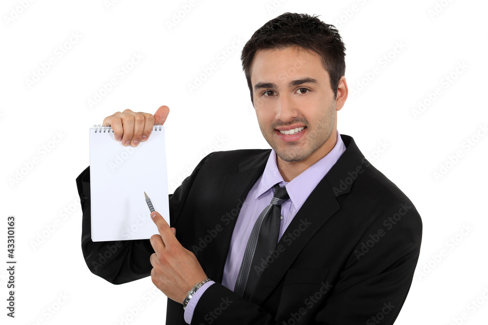 man pointing at his notepad