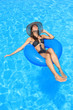 © Netfalls - Young woman enjoying a swimming pool