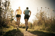 © John Fedele/Blend Images - Caucasian couple running together on path