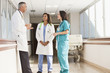 © Blend Images - Doctors and nurse talking in hospital