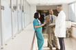 © Blend Images - Doctors and drug salesman talking in hospital
