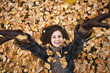 © Mike Kemp/Blend Images - Caucasian woman laying in autumn leaves