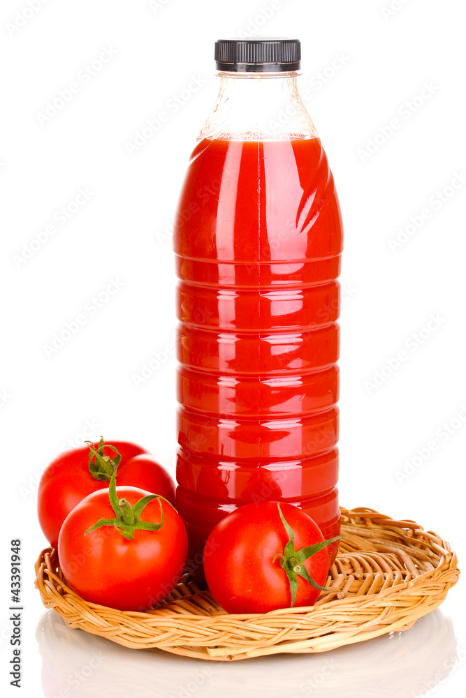Tomato juice in bottle on wicker mat isolated on white