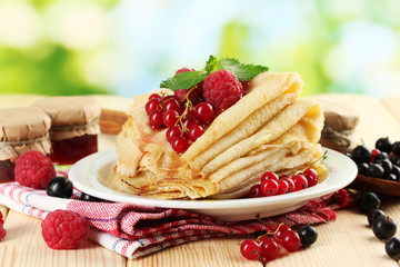 Wall Mural - pancakes with berries, jam and honey