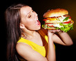 Woman bite hamburger.
