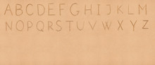 Handwriting English Alphabet On Flat Sand With Empty Space Appro