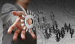 © Nokhoog - businessman hand shows people cogs