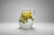 A jug with the fresh drink with the lemon and mint