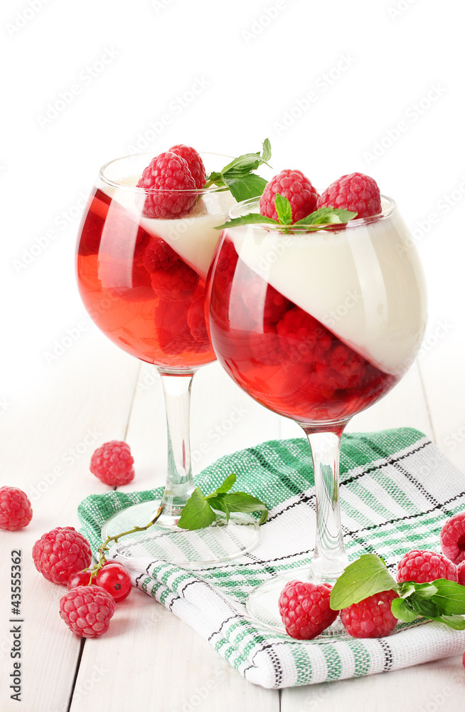 fruit jelly with berries in glasses on wooden table
