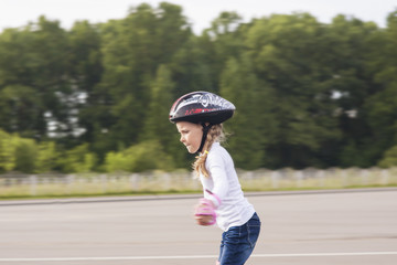 lovely portrait of small little caucasian girl skating