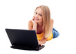 © baranq - Young woman lying down with laptop.