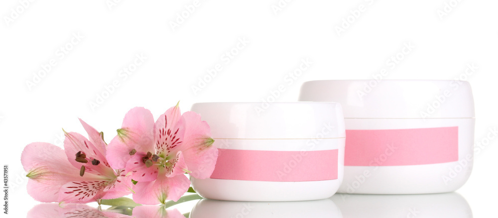 Jars of cream with flower isolated on white