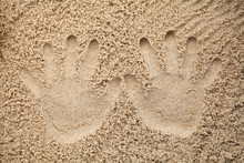 Two Hand Prints In The Sand On Beach