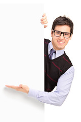 Wall Mural - Smiling handsome male posing behind a panel