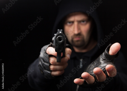 Fotografía Robber with gun holding out hand