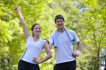 Wall Mural - Couple doing stretching exercise  after jogging