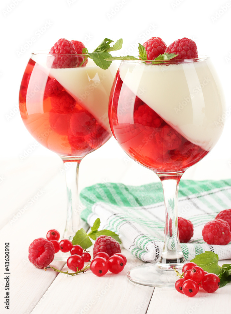 fruit jelly with berries in glasses on wooden table