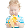 © Andrey Kuzmin - happy pretty child eating banana. healthy food eating concept.