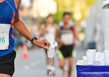 Marathon Racer Catching Cup Of Water