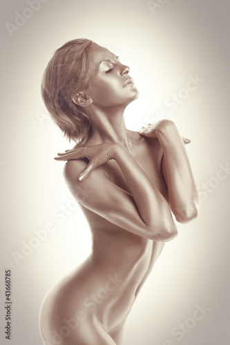 Fototapeta na wymiar Woman art nude portrait with metal skin