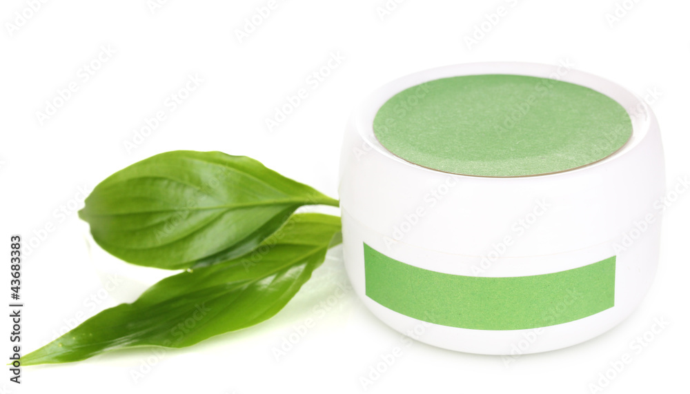 Jar of cream with green leaves isolated on white