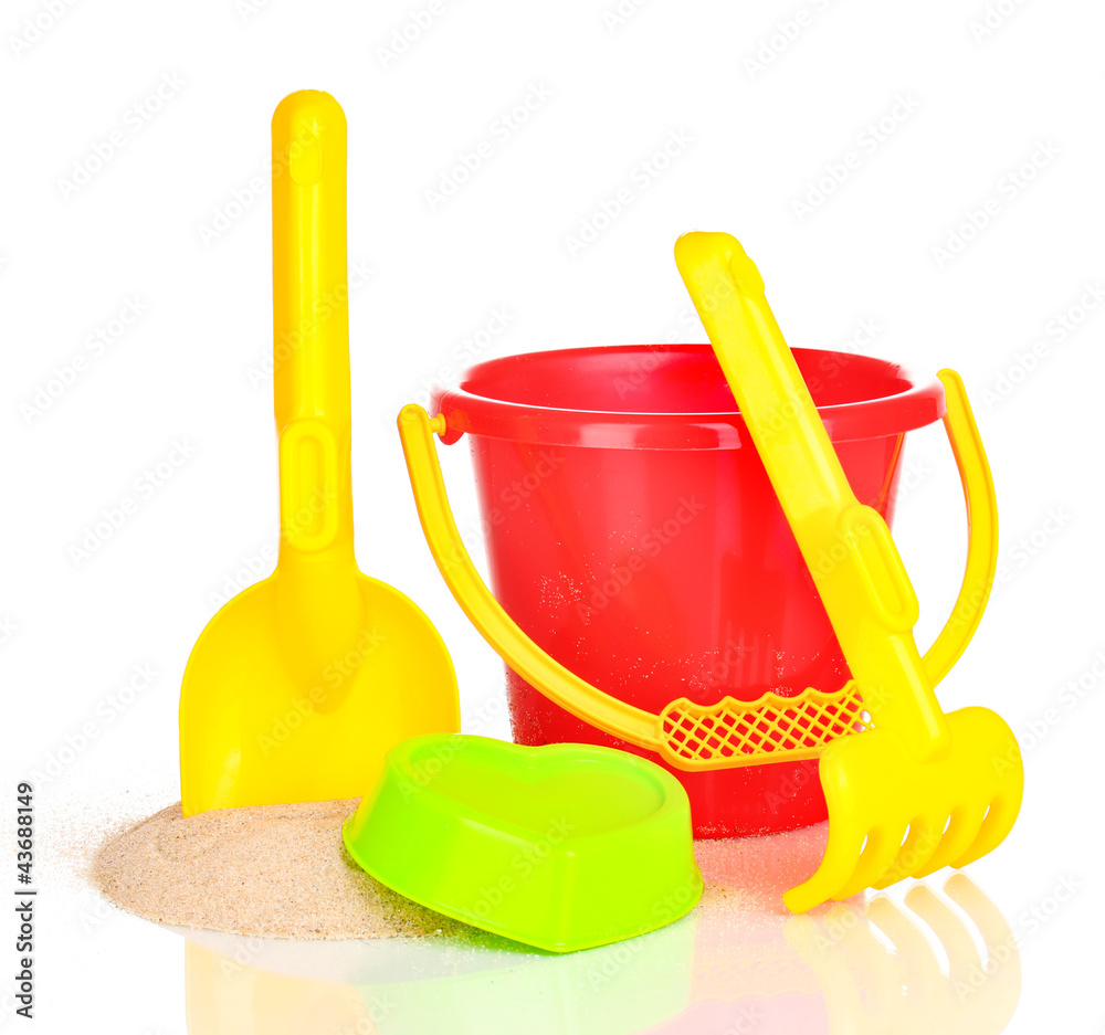Children's beach toys and sand isolated on white