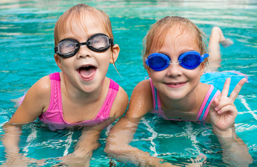 Canvas Print - two little girls playing in the pool