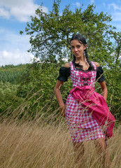 Wall Mural - Wunderhübsche Frau im Dirndl in der Natur