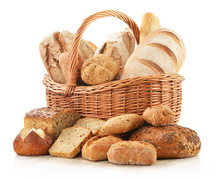 Bread And Rolls In Wicker Basket Isolated On White