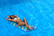© Netfalls - Woman Relaxing in a pool