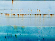 Background of blue grungy steel hull of ocean ship