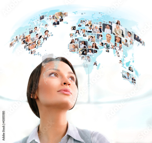 Fototapeta na wymiar Young successful woman looking at worldmap with profile photos o