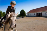 Horse riding - portrait of lovely equestrian on a horse