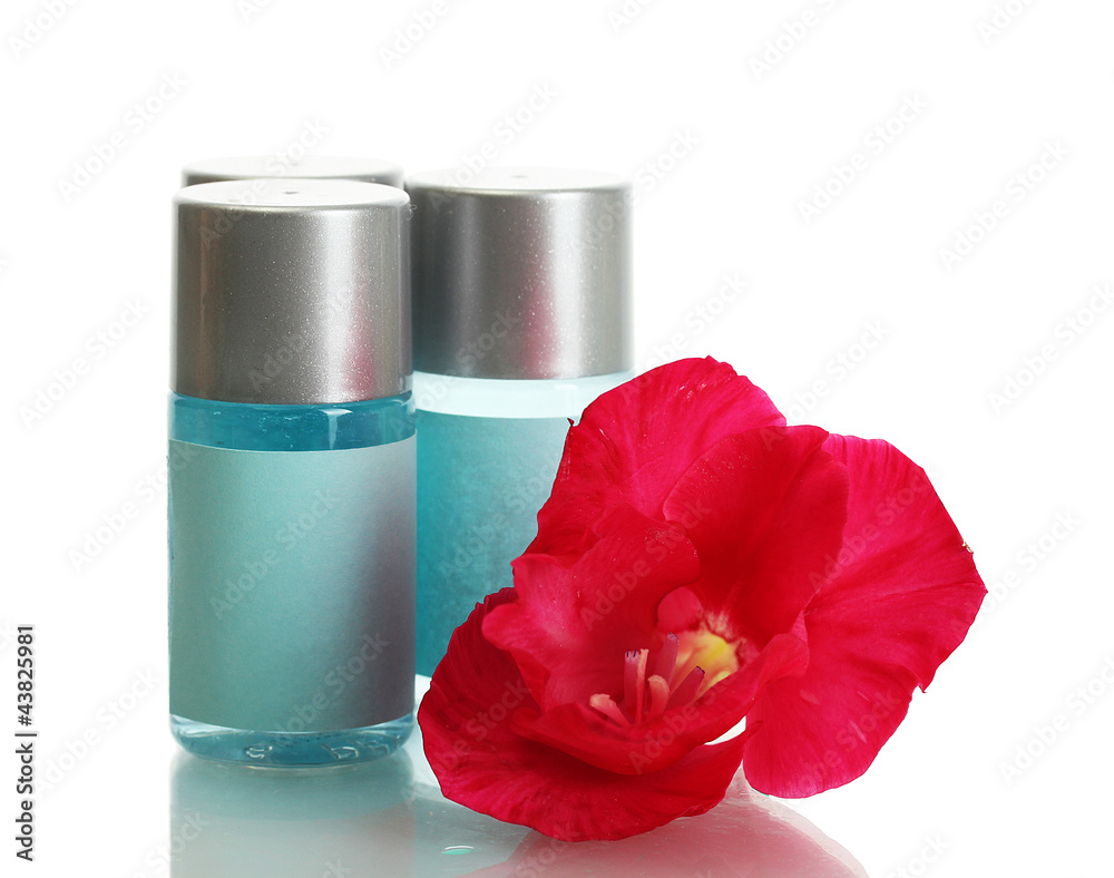 cosmetic bottles and flower, isolated on white.