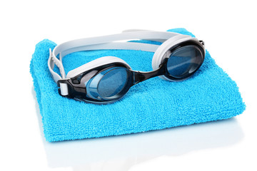 Wall Mural - Swim goggles on towel isolated on white