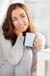 © AILA_IMAGES - attractive young woman drinking coffee at home