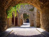 Fototapeta  - Medieval arched street in the old town of Rhodes, Greece